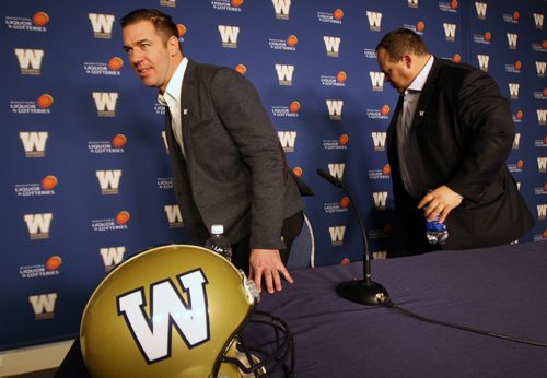 Kyle Walters. Left, heads off to work after being named new General Manager of Winnipeg Blue Bombers at news conference  today at Investors Group Field by President and CEO Wade Miller, right.   See Ed Tait story- Nov 26, 2013   (JOE BRYKSA / WINNIPEG FREE PRESS)