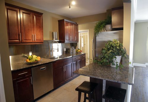 Homes.  The kitchen in 102 Garden Road in St. James, the realtor Daryl Newis.   Todd Lewys story  Wayne Glowacki / Winnipeg Free Press Nov. 26. 2013