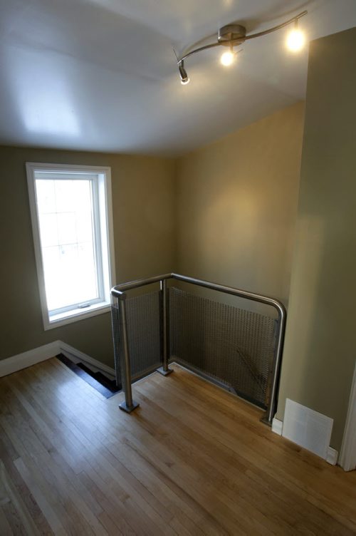 Homes.  The staircase at the second floor level at 102 Garden Road in St. James, the realtor Daryl Newis.   Todd Lewys story  Wayne Glowacki / Winnipeg Free Press Nov. 26. 2013