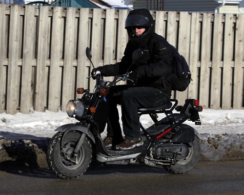 IT'S NOT TOO COOL TO SCOOT! - This scooter dude isn't held down by the ice, snow, and arctic temeeratures on Sargent Ave. over the noon hour. The cool air that is handing over Southern Manitoba is expected to last for days. (NO NAME OF SCOOTER DUDE. HE SCOOTED AWAY...) BORIS MINKEVICH / WINNIPEG FREE PRESS  November 26, 2013
