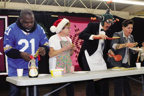 Canstar Community News (From left) Former Winnipeg Blue Bomber James Murphy, Judy Wasylycia-Leis, Al Simmons and Chantel Marostica compete in a pancake eating contest at LITE's 17th annual Wild Blueberry Pancake Breakfast. (JORDAN THOMPSON)