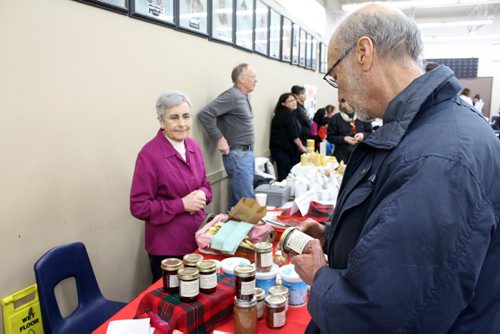 Canstar Community News A man examines some homemade jam and jelly for sale at the Wild Blueberry Pancake Breakfast. (JORDAN THOMPSON)