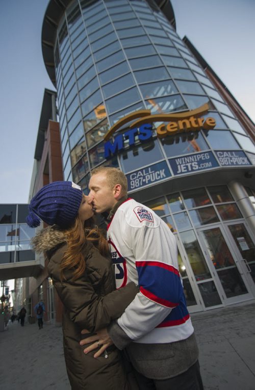131126 Winnipeg - DAVID LIPNOWSKI / WINNIPEG FREE PRESS (November 26, 2013)  Kim Babij-Gesell and husband Taren Gesell kiss outside of the MTS Centre on Tuesday. For a story on the KISS CAM at  Winnipeg Jets games and people's experiences getting caught on them. Kim and Taren are in the story as one of those couples.    [David Sanderson story for 49.8 - INTERSECTION SECTION]