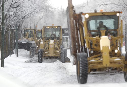 On Thursday, graders scrape Westwood Drive a designated a snow route.  Wayne Glowacki / Winnipeg Free Press Nov. 26. 2013