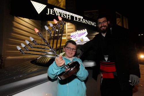 Rabbi Shmuly Altein, right, and his 10 year old nephew Sroly Eizicovics pose for a photo with some mobile lit menorahs. Photo taken at the Jewish Learning Centre 1845 Mathers. BORIS MINKEVICH / WINNIPEG FREE PRESS  November 28, 2013