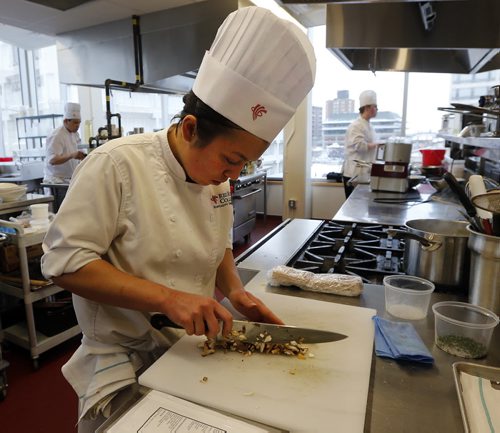 Stdup -Red River College Culinary students took part in the 2013 Manitoba  Pork Competition , ten Culinary Arts  apprentices took part in the Friday morning competition to create a locally sourced pork to produce new recipes  to showcase  modern-day uses for pork Äì in pic Nora Grieve cuts up mushrooms for her  entry , Nov. 29 2013 / KEN GIGLIOTTI / WINNIPEG FREE PRESS