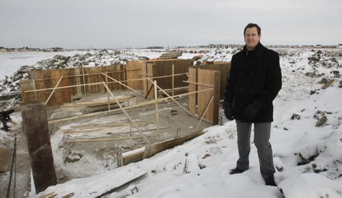 Finance.  Spencer Curtis with Hilton Custom Homes at the Bridgwater Town Centre development site by one of the first of 120 single-attached homes to be built.    Murray McNeill  story. Wayne Glowacki / Winnipeg Free Press Nov. 28. 2013