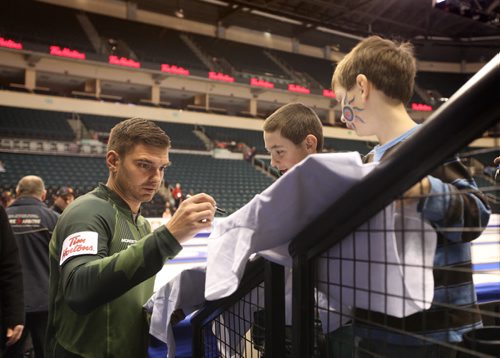 Matt Woznial signs his autographs for young curling fans before going onto the ice for a practice round  at MTS Centre Saturday during TIm Hortons Roar of the Rings Canadian Curling Trials which starts Sunday at MTS Centre.   Nov 30, 2013 Ruth Bonneville / Winnipeg Free Press
