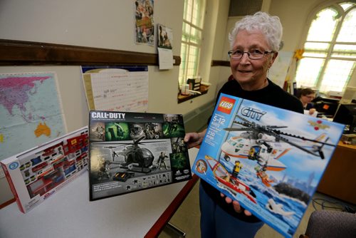 Dianne Cooper from Project Peacemakers displaying some violent and acceptable childrens toys, Saturday, November 30, 2013. (TREVOR HAGAN/WINNIPEG FREE PRESS)