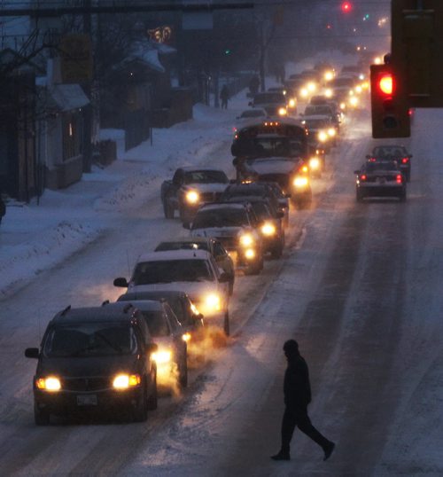 Patience Grasshopper- A row of cars as far as the eye can see Wednesday morning on Arlington St in Winnipeg- Heavy snow has stalled traffic so plan for at least a extra half a hour to get to work this morning. The storm that is moved into southern Manitoba could see amounts of white stuff in the next 24 hours accumulate near 25 cm -See story- Dec 04, 2013   (JOE BRYKSA / WINNIPEG FREE PRESS)