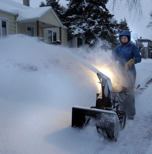 Thursday morning, Darlene Lewis clears snow around her home on Winston Road in Winnipeg after 15cm. snowfall overnight.Wayne Glowacki/ Winnipeg Free Press Dec.5 2013