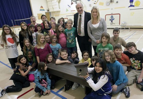 In the foreground, grade 5 student Maya Pogson holds a bird house by the bench that were both presented to all of the students at Ecole Assiniboine by  Tom Ethans, Executive Director of Take Pride Winnipeg! and Sarah Wallace, Communications, Promotions and Education Coordinator with Multi-Material Stewardship Manitoba. Ecole Assiniboine was one of 14 schools in the province that received a bench for their hard work collecting plastic bags, the bench was made with 10,000 plastic bags. The one month bag collection had the participation of 168 schools.   Danielle da Silva story. Wayne Glowacki / Winnipeg Free Press Dec.5 2013