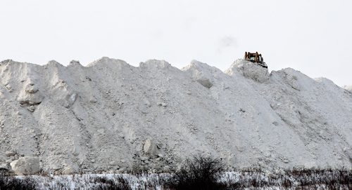 The snow mountain at the Snow Disposal Site on Kenaston Blvd. is growing quickly as almost a constant stream of trucks arrive to deliver loads of snow from city streets and parking lots. 131205 - December 5, 2013 MIKE DEAL / WINNIPEG FREE PRESS