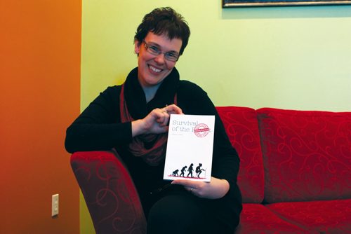 Canstar Community News Nov. 26/13 - Local writer Linda Guest is shown with her first book, Survival of the Flirting Impaired. (DAN FALLOON/CANSTAR COMMUNITY NEWS/HERALD)