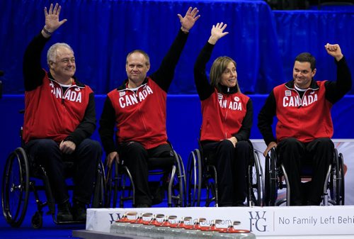 The Canadian wheelchair curling team for the 2014 Paralympic Winter Games was introduced to the MTS Centre crowd midway through the women's semi-final at Roar of the Rings. (from left) Skip Jim Armstrong (Cambridge, Ont.), third Dennis Thiessen (Sanford, Man.), lead Sonja Gaudet (Vernon, B.C.) and alternate Mark Ideson (London, Ont.). Absent was second Ina Forrest (Armstrong, B.C.) 131206 - Friday, December 06, 2013 - (Melissa Tait / Winnipeg Free Press)