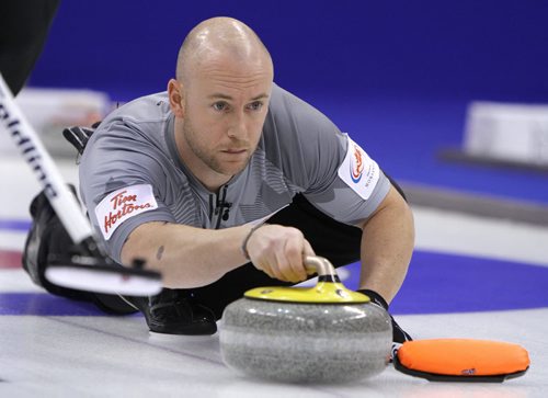 Third Ryan Fry of Brad Jacobs's team shoots during action against John MorrisÄôs team in the menÄôs final of Roar of the Rings curling at the MTS Centre on Sun., Dec. 8, 2013. Photo by Jason Halstead/Winnipeg Free Press