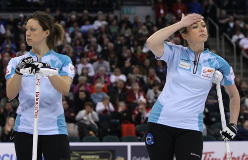 Sherry Middaugh's second Lee Merklinger (left) and lead Leigh Armstrong react to a shot during action against Jennifer JonesÄôs team in the womenÄôs final of Roar of the Rings curling at the MTS Centre on Sat., Dec. 7, 2013. Photo by Jason Halstead/Winnipeg Free Press