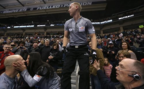 Skip Brad Jacobs looks for his wife in the crowd as teammate Ryan Fry (left) gets a kiss while celebrating after defeating John MorrisÄôs team in the menÄôs final of Roar of the Rings curling at the MTS Centre on Sun., Dec. 8, 2013. Jacobs won the right to represent Canada at the Winter Olympics in Sochi, Russia, in February. Photo by Jason Halstead/Winnipeg Free Press