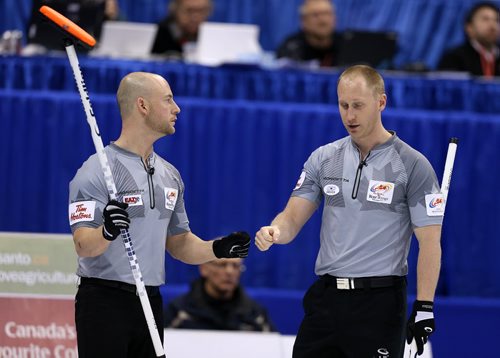 Skip Brad Jacobs (right) and third Ryan Fry celebrate a shot on the way to defeating John MorrisÄôs team in the menÄôs final of Roar of the Rings curling at the MTS Centre on Sun., Dec. 8, 2013. Jacobs won the right to represent Canada at the Winter Olympics in Sochi, Russia, in February. Photo by Jason Halstead/Winnipeg Free Press
