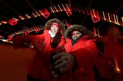 Michelle Truong (left) and Alissa Patel hand out sweet treats as part of a PC Plus promotion at the Canad Inns Winter Wonderland drive-through holiday light park at Red River Exhibition Park on Sun., Dec. 8, 2013. Photo by Jason Halstead/Winnipeg Free Press