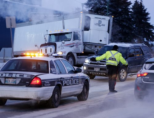 A Semi is blocking east traffic on Grant  in front of the Super Store , police are directing traffic around the  blockage -Dec. 9 2013 / KEN GIGLIOTTI / WINNIPEG FREE PRESS