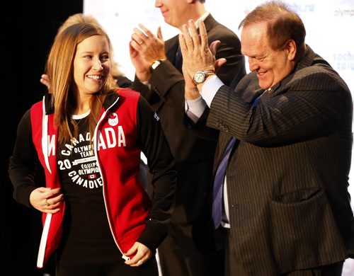 A happy Kaitlyn Lawes  from the Jennifer Jones team is apauded by COC President Marcel Aubut after he presented her with her Canadian  Olympic Team jacket , The Canadian Olympic Committee nominated Canada's winning curling teams , Jennifer Jones  and Brad Jacobs  team  to the Sochi Olympics , By COC President Marcel Aubut -Dec. 9 2013 / KEN GIGLIOTTI / WINNIPEG FREE PRESS