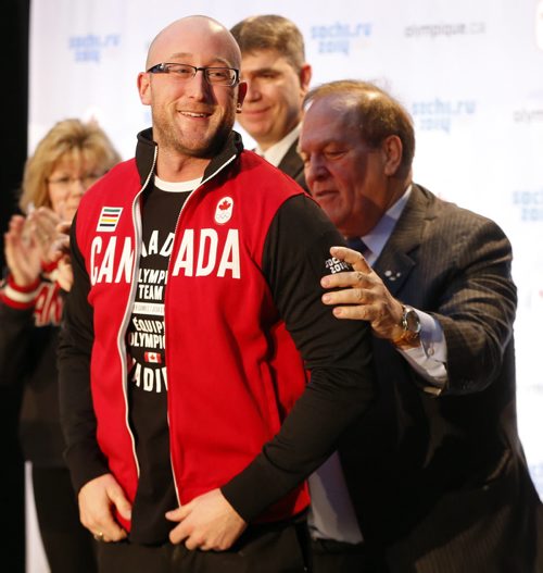 Marcel Aubut claps after giving lead Ryan Harden  for  Team Brad Jacobs his  Olympic team jacket - The Canadian Olympic Committee nominated Canada's winning curling teams , Jennifer Jones  and Brad Jacobs  team  to the Sochi Olympics , By COC President Marcel Aubut - Dec. 9 2013 / KEN GIGLIOTTI / WINNIPEG FREE PRESS