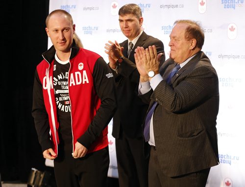 right, Marcel Aubut claps after giving men's winning skip Brad Jacobs his  Olympic team jacket , middle is Can. Curling Ass. Greg Stremlaw ,The Canadian Olympic Committee nominated Canada's winning curling teams , Jennifer Jones  and Brad Jacobs  team  to the Sochi Olympics , By COC President Marcel Aubut -Dec. 9 2013 / KEN GIGLIOTTI / WINNIPEG FREE PRESS / Dec. 9 2013 / KEN GIGLIOTTI / WINNIPEG FREE PRESS