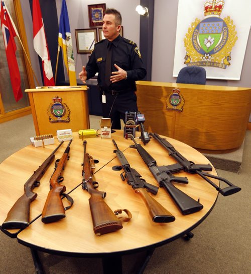 Constable Jason Michalyshen  in pic with guns at  Wpg Police Service Newser , WPS seized drugs and guns from two residences in the 500 block of Chalmers Ave and 3 occupants arrested  and  were taken into custody , a quantity of Meth , Marijuana  hunting and assault weapons were seized in the raid . ** weapons on display were not seized from this arrest , those are still being processed , these represent the kinds of guns found  Dec. 9 2013 / KEN GIGLIOTTI / WINNIPEG FREE PRESS