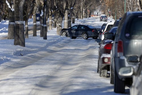 single vehicle car into tree  on an icy rutted , unsanded  Overdale St. -Last weeks snow fall  has  left pack snow and ice  rut hazards to traffic. The city has chosen not to scrape the streets to the pavement .  Dec. 9 2013 / KEN GIGLIOTTI / WINNIPEG FREE PRESS