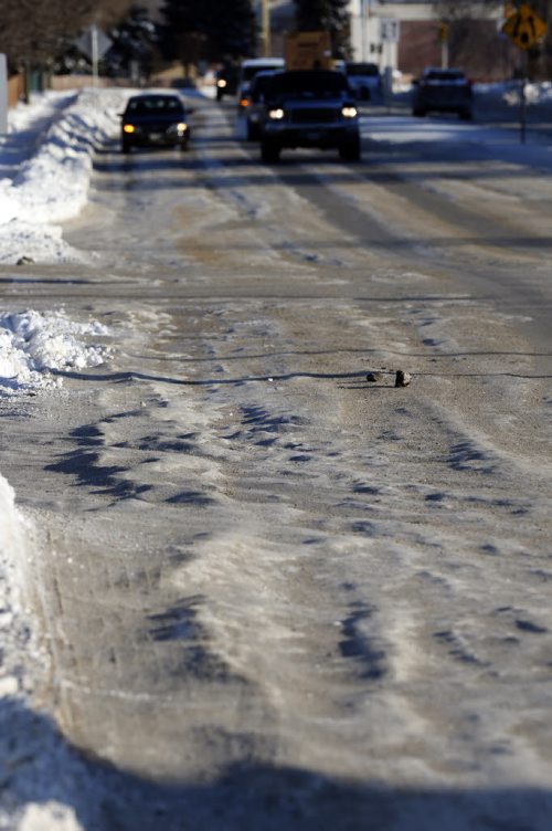 Ice ruts on Ness Ave  at Stugeon Rd. Last weeks snow fall  has  left pack snow and ice  rut hazards to traffic. The city has chosen not to scrape the streets to the pavement .  Dec. 9 2013 / KEN GIGLIOTTI / WINNIPEG FREE PRESS