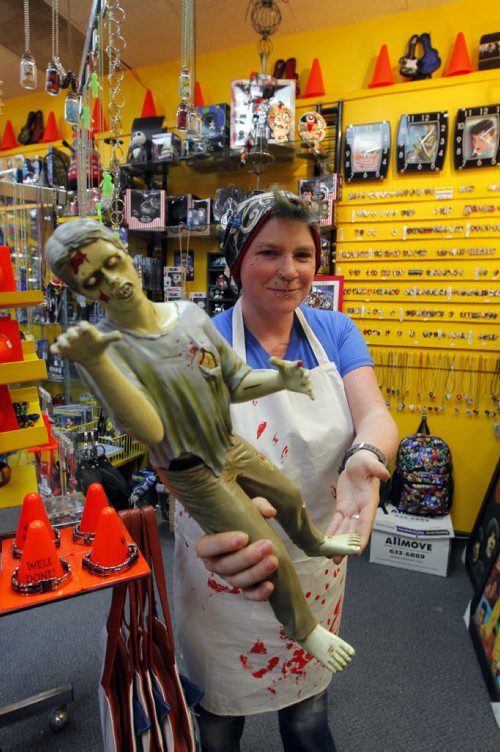 49.8 - INTERSECTION - Christmas Gift Guide Gifts. Pylon sells a butcher's apron that looks like chef is covered in blood. Employee Sandra Sturrock poses for a photo. BORIS MINKEVICH / WINNIPEG FREE PRESS  December 9, 2013