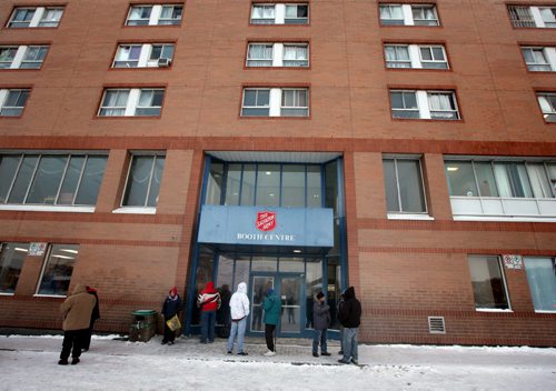 Sally Ann Clients cluster around the entrance to the Booth Center at 180 Henry Tuesday afternoon. Homeless shelters are dealing with higher demand for shelter because of the cold weather. Salvation Army regularly provides shelter when other centres are full.  December 10, 2013 - (Phil Hossack / Winnipeg Free Press)