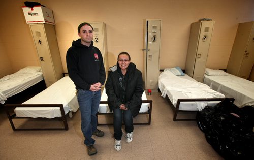 Mark Stewart of the Salvation Army poses with shelter client Farrah Richards in the Army's shelter bunk room at 180 Henry Tuesday afternoon.Homeless shelters are dealing with higher demand for shelter because of the cold weather. Salvation Army regularly provides shelter when other centres are full.  December 10, 2013 - (Phil Hossack / Winnipeg Free Press)