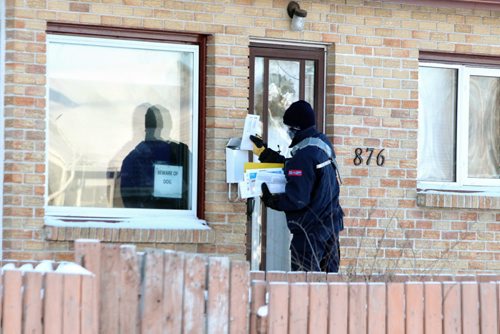 A mail carrier works a route on Mountain Avenue Wednesday morning.  131211 December 11, 2013 Mike Deal / Winnipeg Free Press