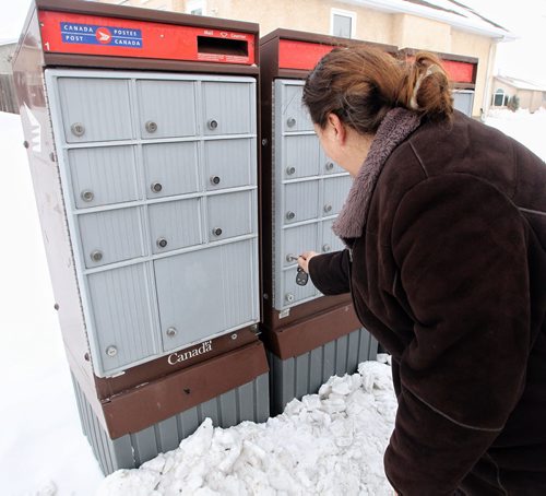 Angie Lawrence has no problem with getting her mail from her super box, she lives within sight of it and is even happy to report that the mail-person who delivers to the box will sometimes deliver parcels right to her door even thought they don't have to. 131211 - December11, 2013 MIKE DEAL / WINNIPEG FREE PRESS