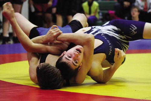 Canstar Community News Evan Gobeil (right) finds himself in a tight spot during his match Saturday at Elmwood High School. (JORDAN THOMPSON)