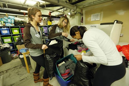 LtoR  UofM Volleyball team members Jordana Milne , Rachel Cockrell and Atria Clunis  help sort new donations of clothing - Siloam Mission is bouncing back but much work needs to be done  , the medical / dental centre was put out of commission by Thursday's sprinkler  break and flood, 6000 sq ft of the building was  effected , 4000 lbs of food was damaged and thrown out.   Other food will be inspected . The food service and  sleeping area was un-effected . Fans line the medical centre  hall ways as  the clean up continues. A dentist chair was shorted out by the water and will likely,  need replacing. donations of cash are greatly appriciated Dec. 13 2013 / KEN GIGLIOTTI / WINNIPEG FREE PRESS