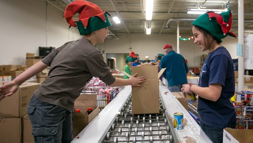 (will add names this afternoon) Oakenwald Elementary School students packed around 500 food hampers at Christmas Cheer Board on Friday for distribution to families in need.  131213 - Friday, {month aame} 13, 2013 - (Melissa Tait / Winnipeg Free Press)