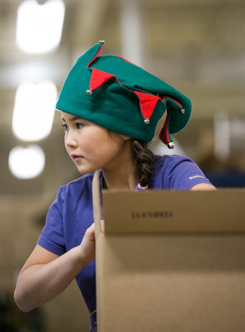 (will add names this afternoon) Oakenwald Elementary School students packed around 500 food hampers at Christmas Cheer Board on Friday for distribution to families in need. Tiffany Cheng.  131213 - Friday, {month aame} 13, 2013 - (Melissa Tait / Winnipeg Free Press)