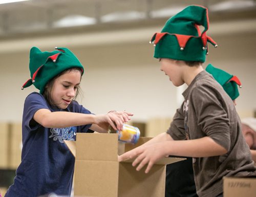 (will add names this afternoon) Oakenwald Elementary School students packed around 500 food hampers at Christmas Cheer Board on Friday for distribution to families in need.  131213 - Friday, {month aame} 13, 2013 - (Melissa Tait / Winnipeg Free Press)