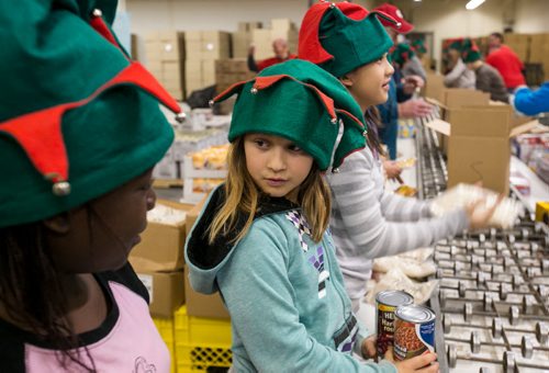 (will add names this afternoon) Oakenwald Elementary School students packed around 500 food hampers at Christmas Cheer Board on Friday for distribution to families in need. Here are the names from left to right:

picture 1: Nicole   Ngwalla          Jordan Graveline     Quynh Anh Nguyen 131213 - Friday, {month aame} 13, 2013 - (Melissa Tait / Winnipeg Free Press)