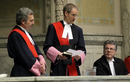 Hon Glenn Joyal, Chief Justice of the Court of Queen's Bench, listens as  Hon. Justice James G. Edmond reads his oaths,  Hon Richard Chartier Chief Justice of Manitoba (Court of Appeal), watches (right) at the swearing in ceremony of Justices Edmond and Guy Friday at the downtown court house. See story. December 13, 2013 - (Phil Hossack / Winnipeg Free Press)
