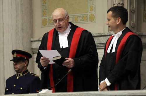 Hon Ken Champagne watches as Hon Associate Chief Judge John P Guy reads his oath, during a swearing in ceremony Friday at the downtown court house. See story. December 13, 2013 - (Phil Hossack / Winnipeg Free Press)