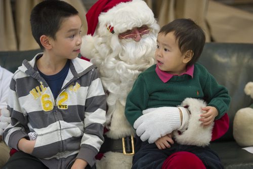 131214 Winipeg - DAVID LIPNOWSKI / WINNIPEG FREE PRESS (December 14, 2013)  Where: Red River College, 2055 Notre Dame, in the cafeteria for Breakfast with Santa  Santa chats with brother Alexandre (left) and Alfred Nguyen. Wayne Johnson who was Santa at a kids' breakfast at Red River College Saturday December 14, 2013.   Dave Sanderson Story for the Intersection section on the men behind the Santa beards at Christmas time