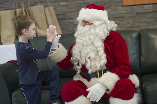 131214 Winipeg - DAVID LIPNOWSKI / WINNIPEG FREE PRESS (December 14, 2013)  Where: Red River College, 2055 Notre Dame, in the cafeteria for Breakfast with Santa  Santa high fives Sam Boulet. Wayne Johnson who was Santa at a kids' breakfast at Red River College Saturday December 14, 2013.   Dave Sanderson Story for the Intersection section on the men behind the Santa beards at Christmas time