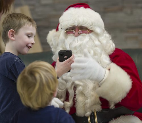 131214 Winipeg - DAVID LIPNOWSKI / WINNIPEG FREE PRESS (December 14, 2013)  Where: Red River College, 2055 Notre Dame, in the cafeteria for Breakfast with Santa  Santa chats Sam (age 4 with phone) and Eric Boulet. Wayne Johnson who was Santa at a kids' breakfast at Red River College Saturday December 14, 2013.   Dave Sanderson Story for the Intersection section on the men behind the Santa beards at Christmas time