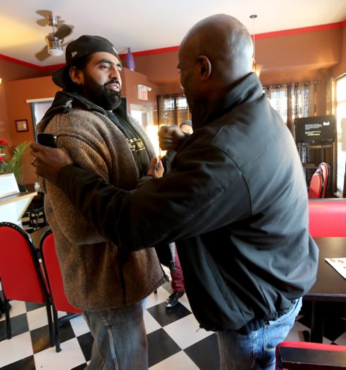 Obby Khan, former Winnineg Blue Bomber and owner of Shawarma Khan, arrives to support Milt Stegall inside Thea's Diner in Morris, Manitoba. Stegall flew up from Atlanta to show support for Thea Morris in the small community, Saturday, December 14, 2013. (TREVOR HAGAN/WINNIPEG FREE PRESS)