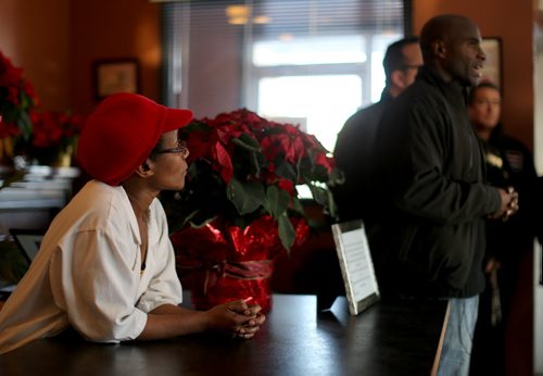 Thea Morris, left, looks on while Milt Stegall addresses the media inside Thea's Diner in Morris, Manitoba. Milt Stegall arrived to show support in the small community, Saturday, December 14, 2013. (TREVOR HAGAN/WINNIPEG FREE PRESS)