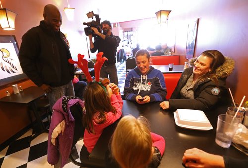 Milt Stegall greeting customers inside Thea's Diner in Morris, Manitoba. Stegall flew up from Atlanta to show support for Thea Morris in the small community, Saturday, December 14, 2013. (TREVOR HAGAN/WINNIPEG FREE PRESS)